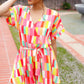 Eyes On You Coral & Yellow Geo Abstract Surplice Woven Romper