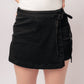 Bentli High Rise Side Tie Denim Skort in Black